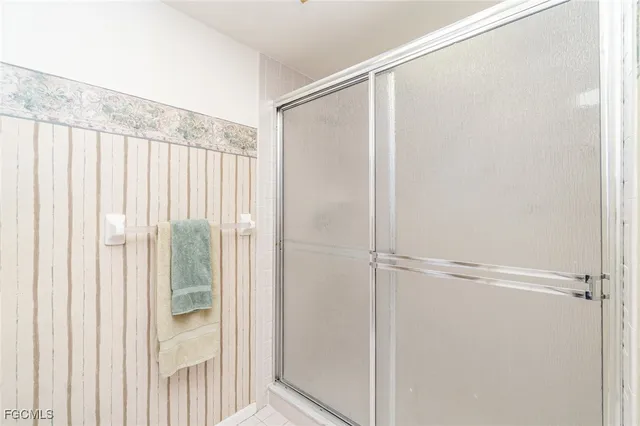 a bathroom with a glass shower door