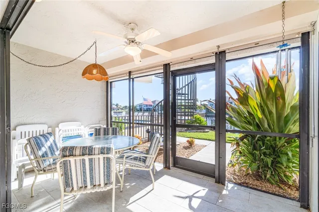 a dining room with furniture water view and a floor to ceiling window