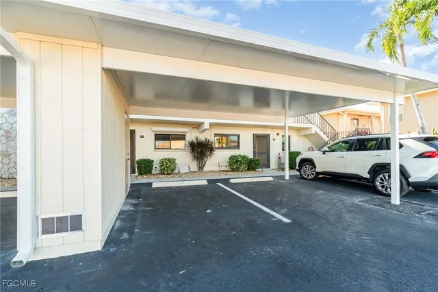 a view of a cars park in front of a building
