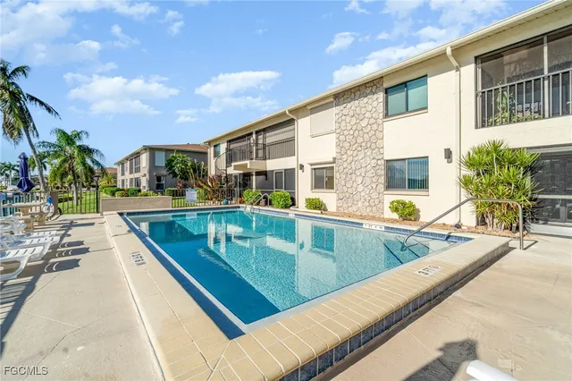 a view of swimming pool with outdoor seating