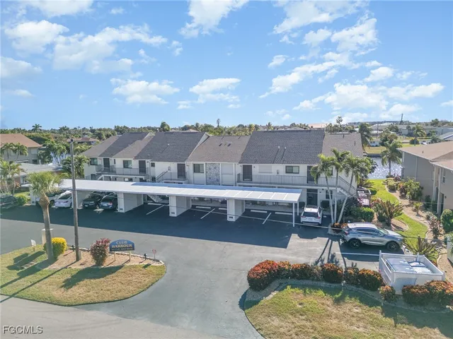 a view of a house with pool and chairs