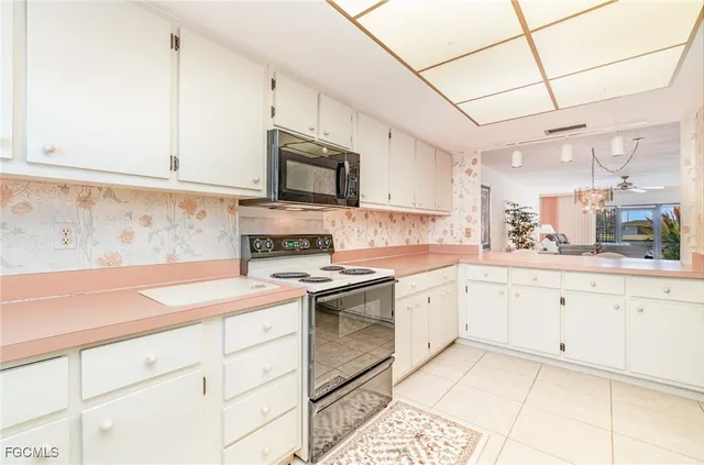 a kitchen with a sink stove top oven and cabinets