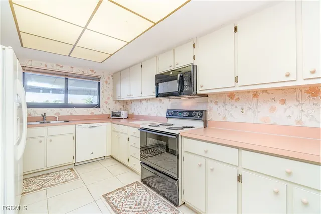 a kitchen with a stove a sink and a refrigerator