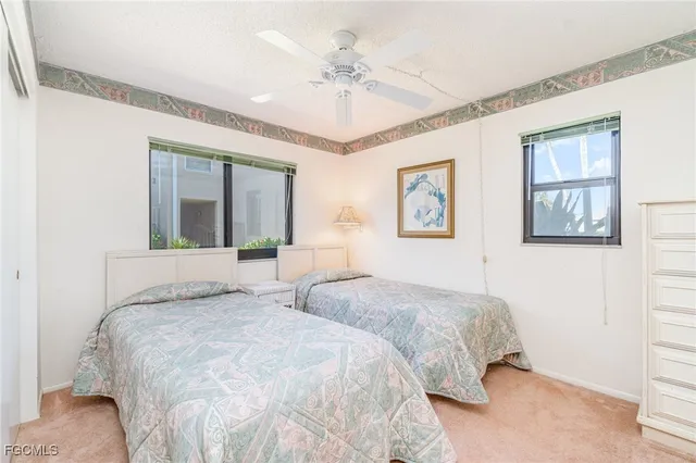 a bedroom with two beds and a chandelier