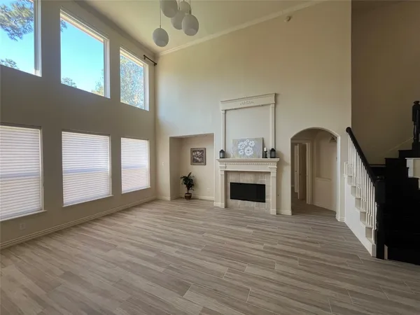 a view of an empty room with window and fireplace