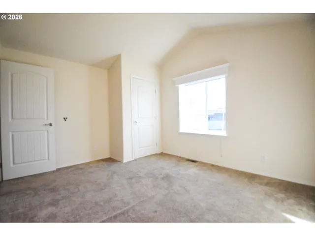 a view of an empty room with a window