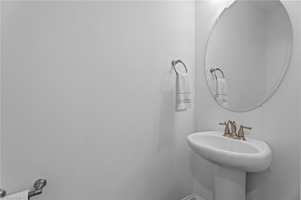 7111 Lambert Lake Road Stokesdale, NC 27357 - Photo 26 of 36 Half bath downstairs off of the kitchen