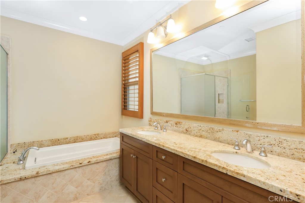 220 Kempton Irvine, CA 92620 - Photo 32 of 42 a bathroom with a granite countertop sink and a bathtub