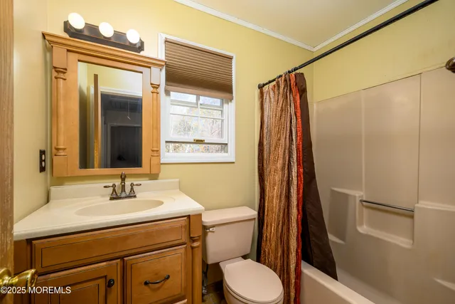 an empty room with a ceiling fan and window