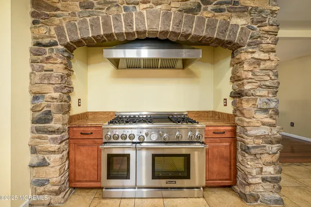 a kitchen with stainless steel appliances granite countertop a refrigerator and a stove