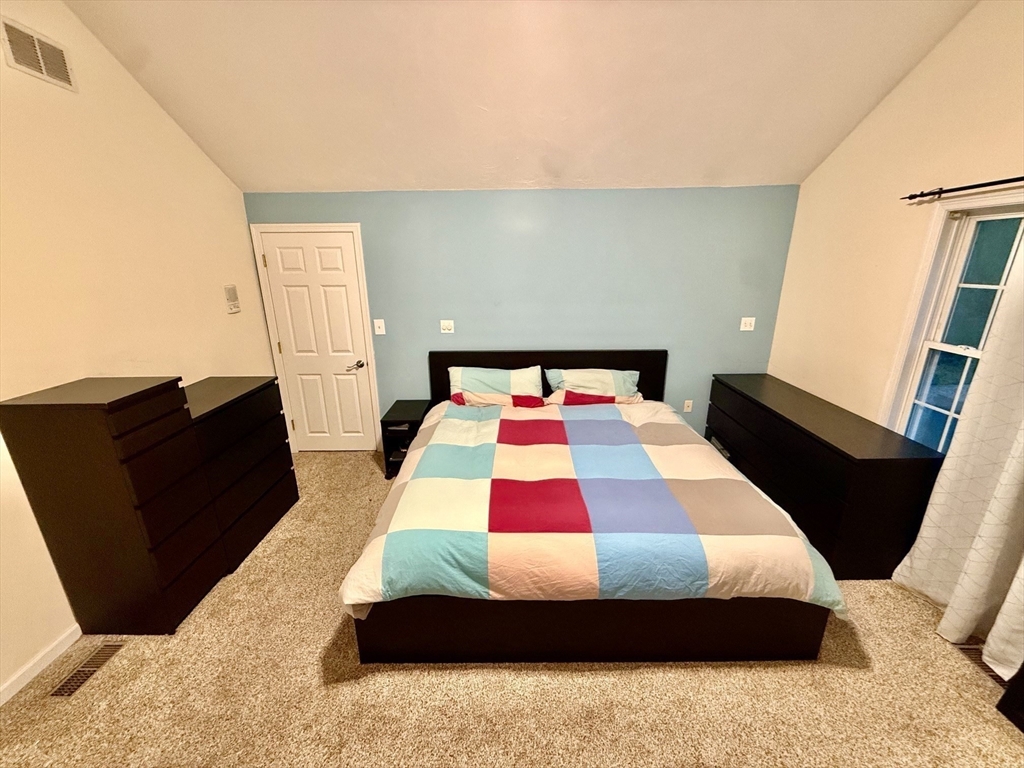 19 Fairview Road, Unit A Framingham, MA 01702 - Photo 11 of 28 a bedroom with a bed and wooden floor