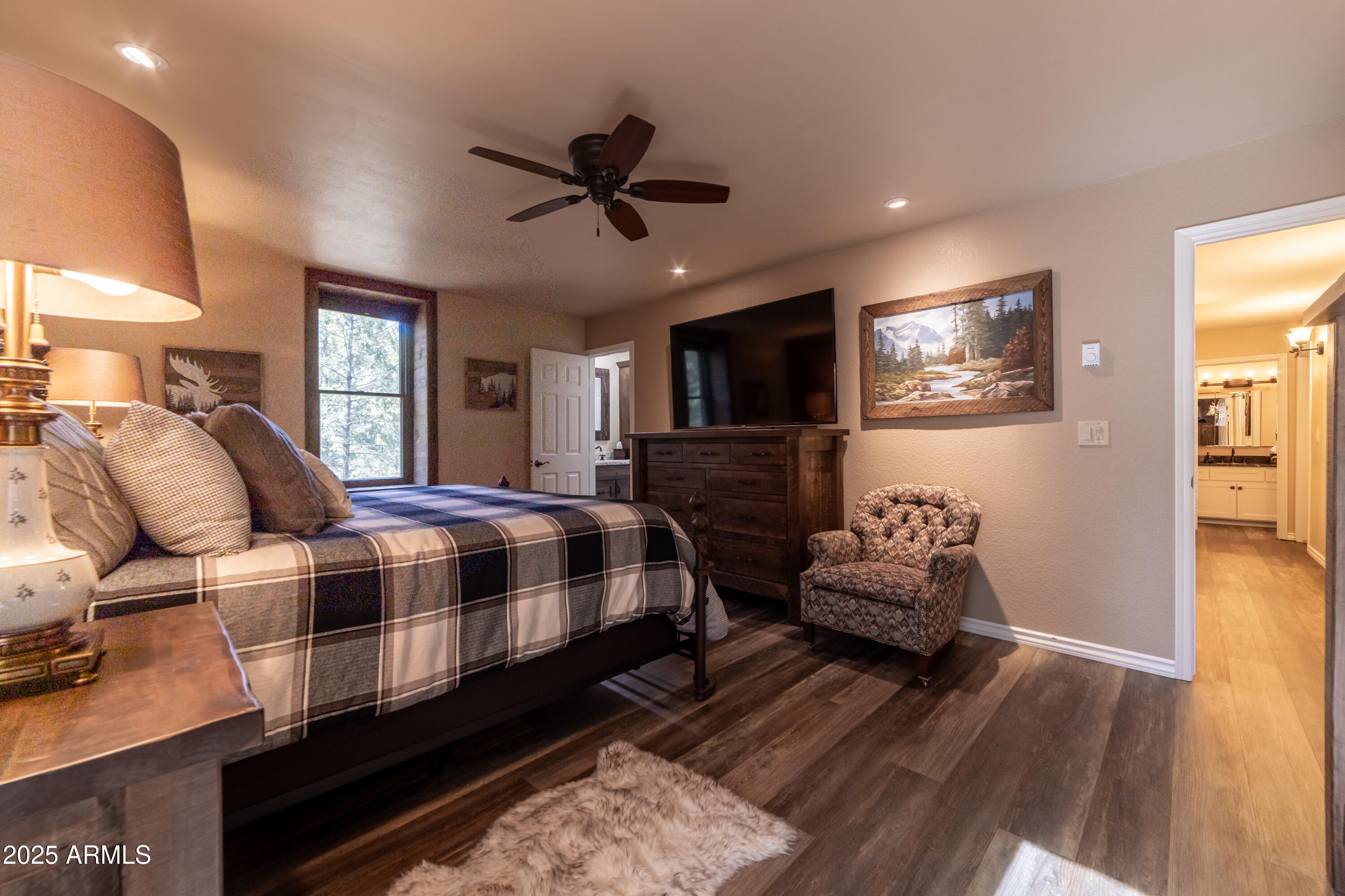 3929 East Sheldon Road Prescott, AZ 86303 - Photo 18 of 36 a spacious bedroom with a bed and wooden floor
