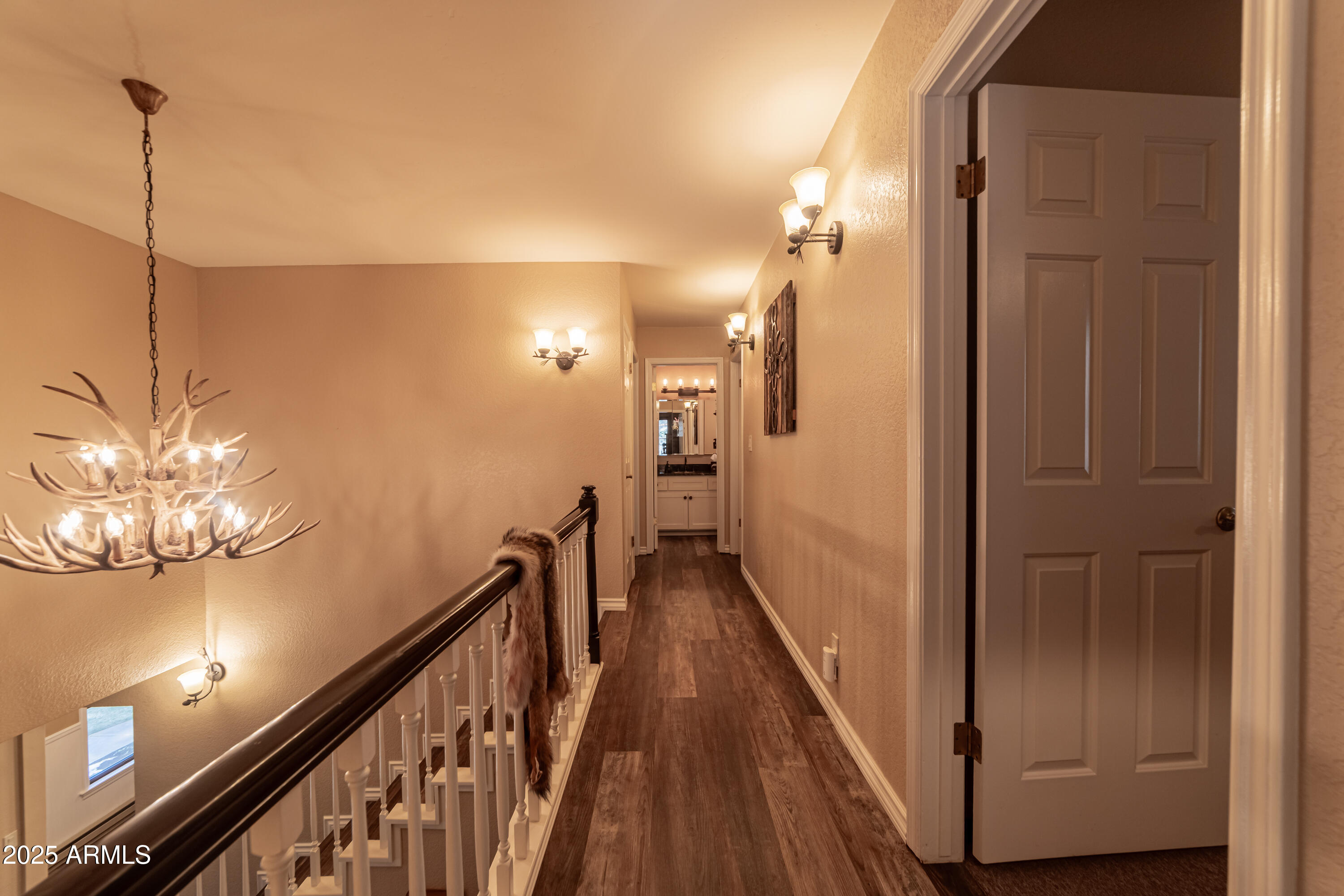 3929 East Sheldon Road Prescott, AZ 86303 - Photo 22 of 36 a view of a hallway with wooden floor and stairs