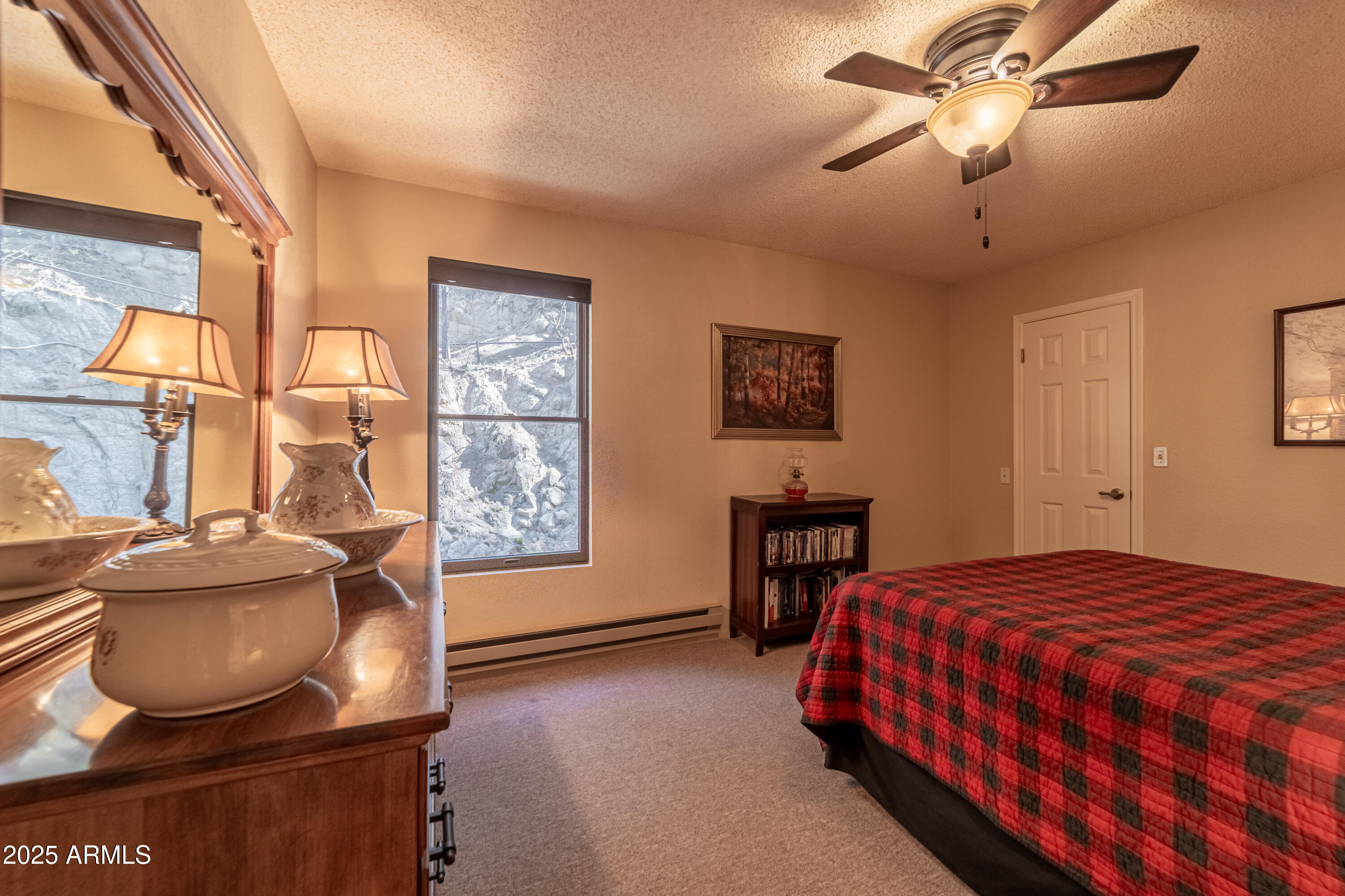 3929 East Sheldon Road Prescott, AZ 86303 - Photo 23 of 36 a bedroom with a bed and wooden floor