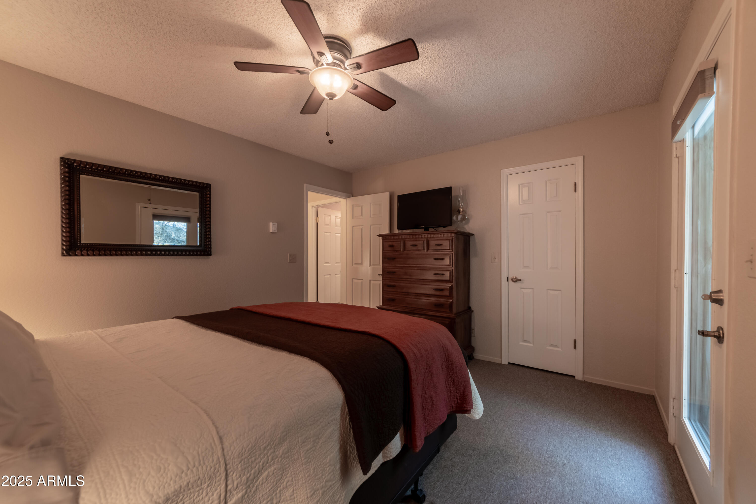 3929 East Sheldon Road Prescott, AZ 86303 - Photo 28 of 36 a bedroom with a bed and a chandelier