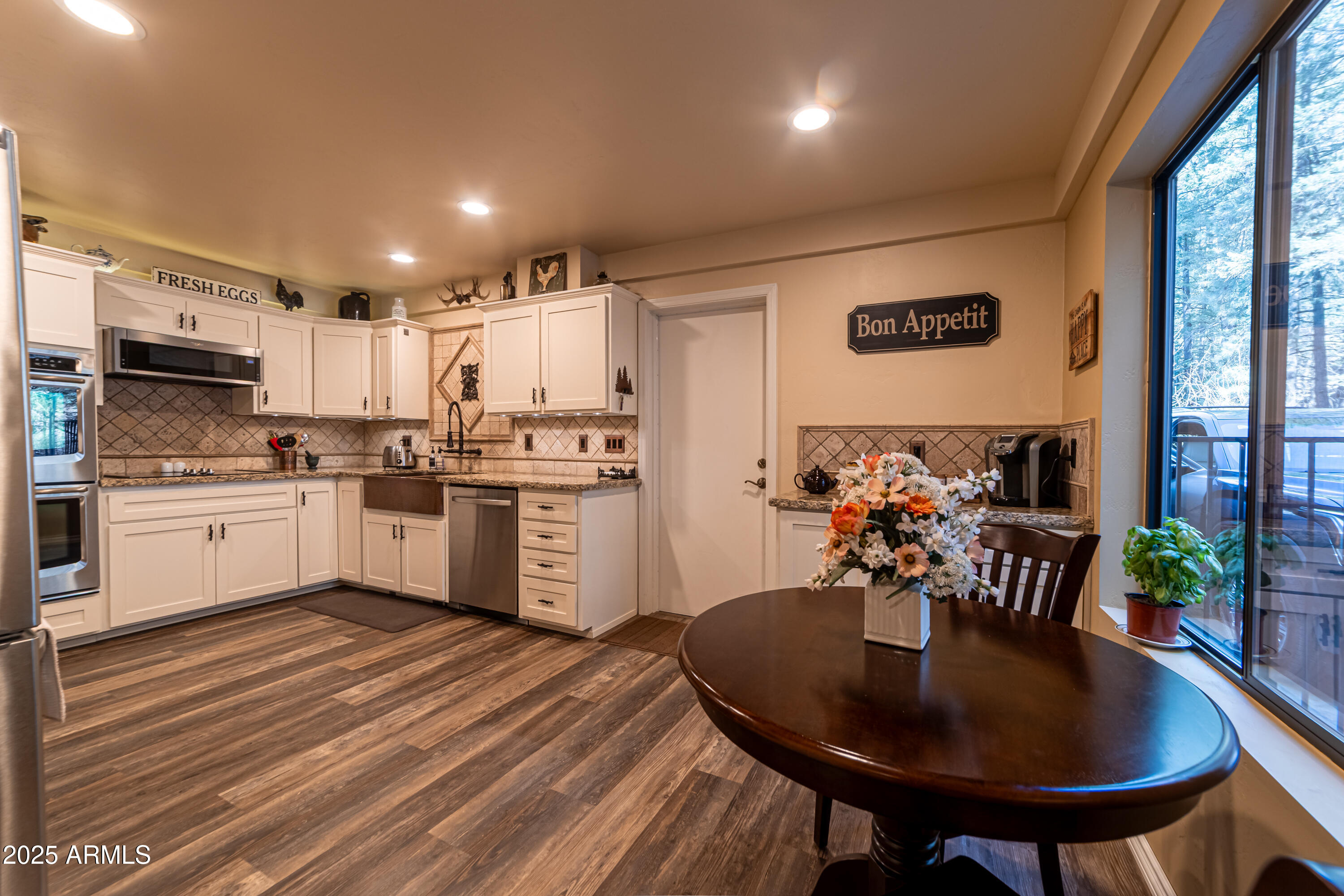 3929 East Sheldon Road Prescott, AZ 86303 - Photo 5 of 36 a kitchen with a sink white cabinets and stainless steel appliances
