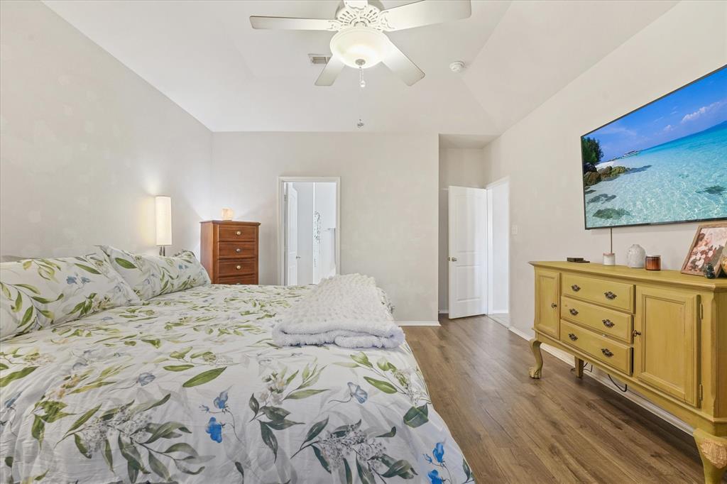 3801 Surf Street Denton, TX 76208 - Photo 19 of 29 Bedroom featuring dark wood-style flooring, ceiling fan, and ensuite bathroom