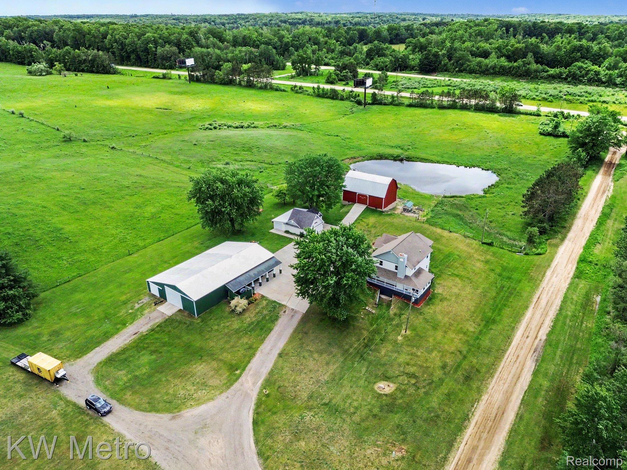 2682 East Haskell Lake Road Harrison, MI 48625 - Photo 51 of 61 Expansive property featuring a main residence, multiple outbuildings, a private pond, and extensive green space