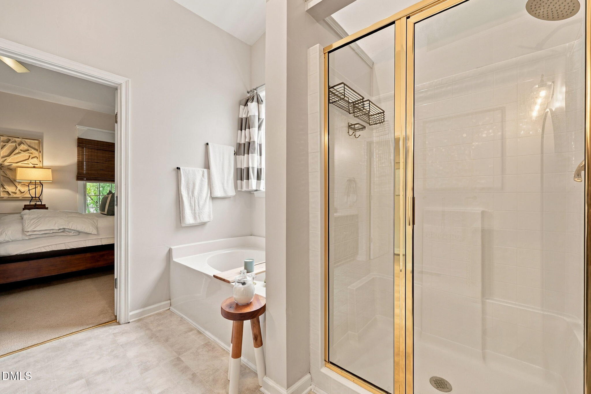 6 Sydenham Road Durham, NC 27713 - Photo 30 of 44 Spa-inspired primary bathroom featuring a freestanding soaking tub with chrome fixtures, a walk-in shower enclosure with brushed gold framing and frameless glass doors, marble-finish flooring, soft-close cabinetry, and integrated storage shelving