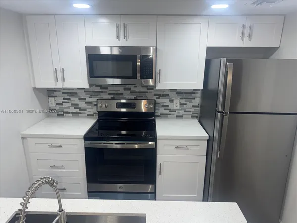 a kitchen with a stove and a microwave