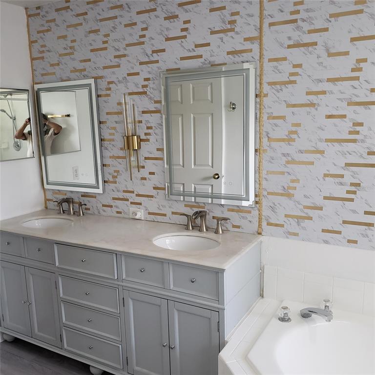 14111 Colonial Spring Way Orlando, FL 32826 - Photo 14 of 26 a bathroom with a sink and a mirror