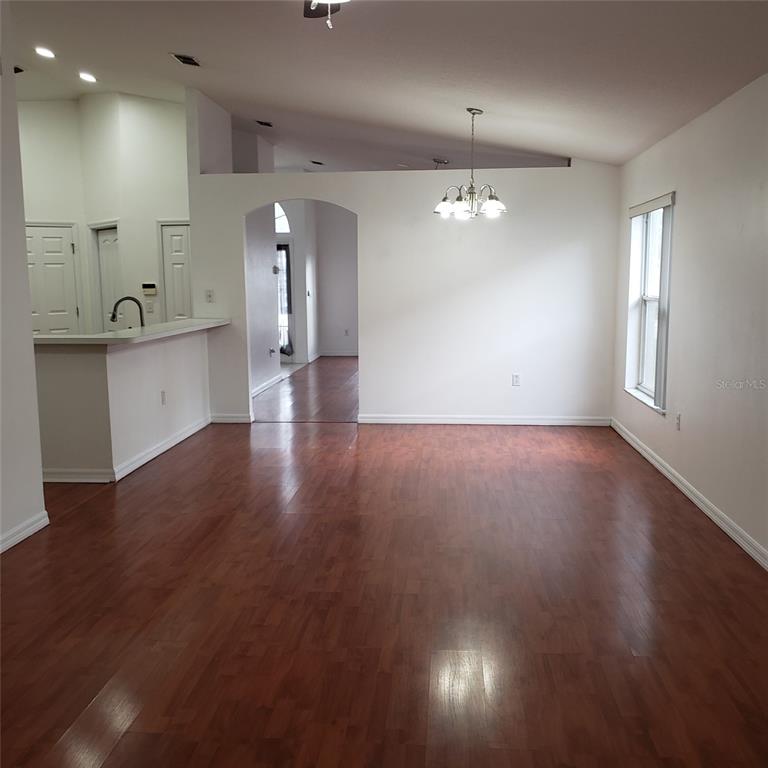 14111 Colonial Spring Way Orlando, FL 32826 - Photo 19 of 26 an empty room with wooden floor and windows
