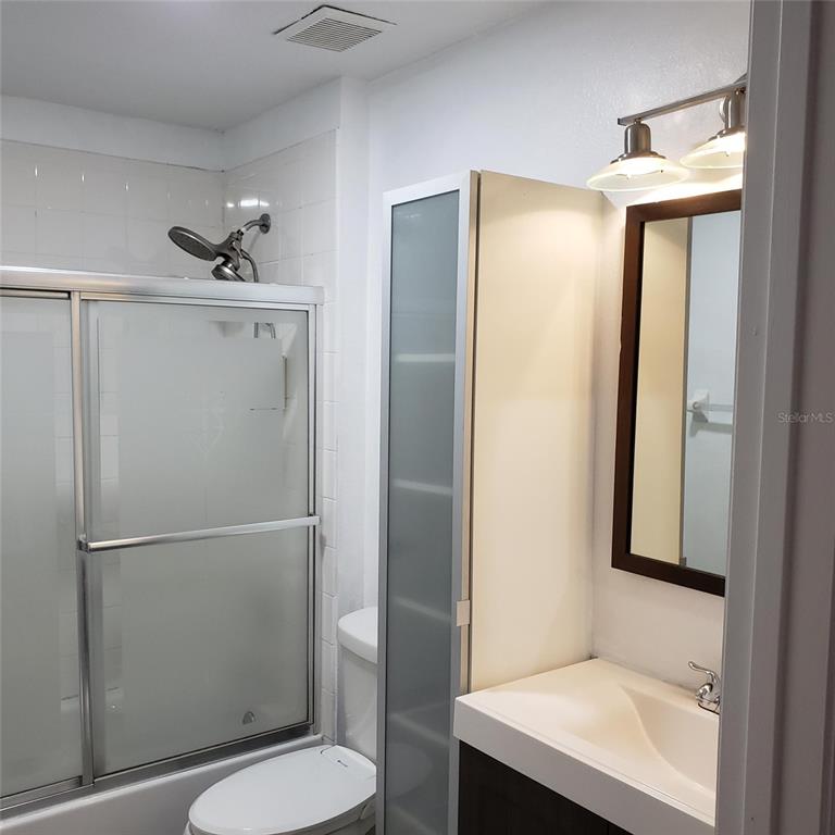 14111 Colonial Spring Way Orlando, FL 32826 - Photo 21 of 26 a bathroom with a toilet a sink and shower