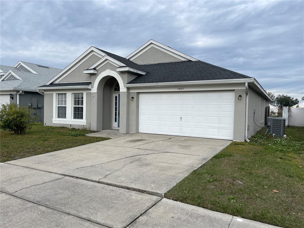 14111 Colonial Spring Way Orlando, FL 32826 - Photo 3 of 26 a front view of a house with a yard and garage