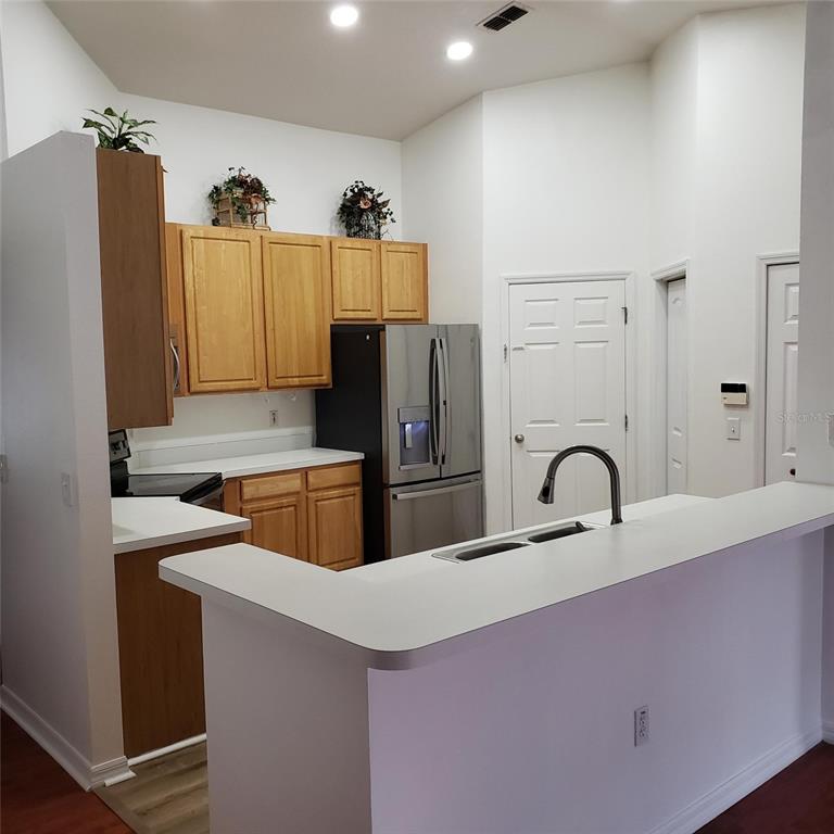 14111 Colonial Spring Way Orlando, FL 32826 - Photo 7 of 26 a kitchen with refrigerator and sink