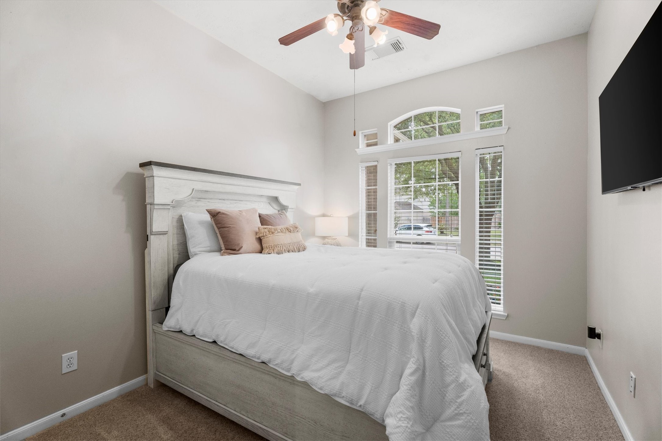 18502 Cascade Timbers Lane Tomball, TX 77377 - Photo 26 of 43 A spacious secondary bedroom offers fresh paint, a ceiling fan, and ample storage, creating a comfortable and inviting space for family or guests.