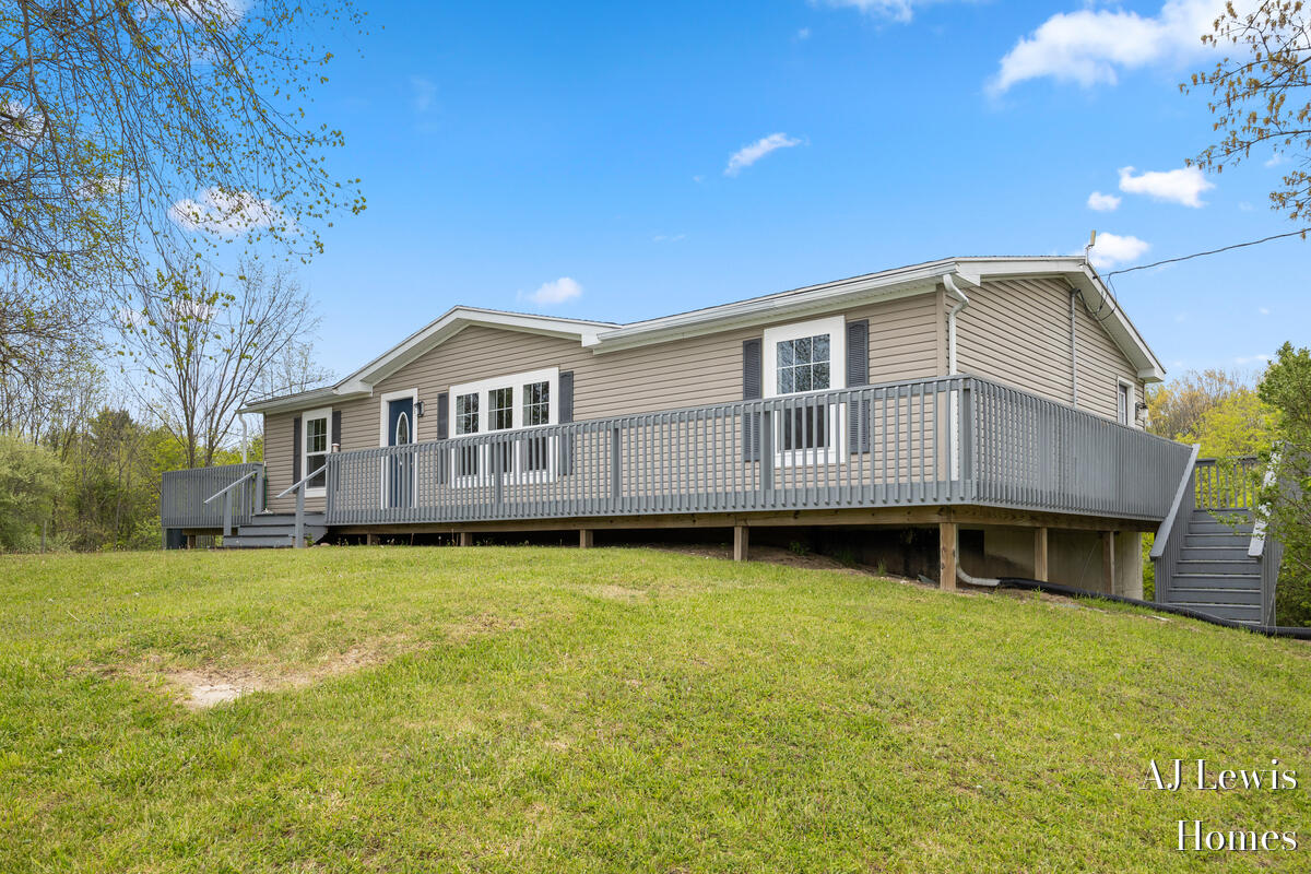 4810 Buehler Road Hastings, MI 49058 - Photo 2 of 25 Large wrap around deck w/stairs