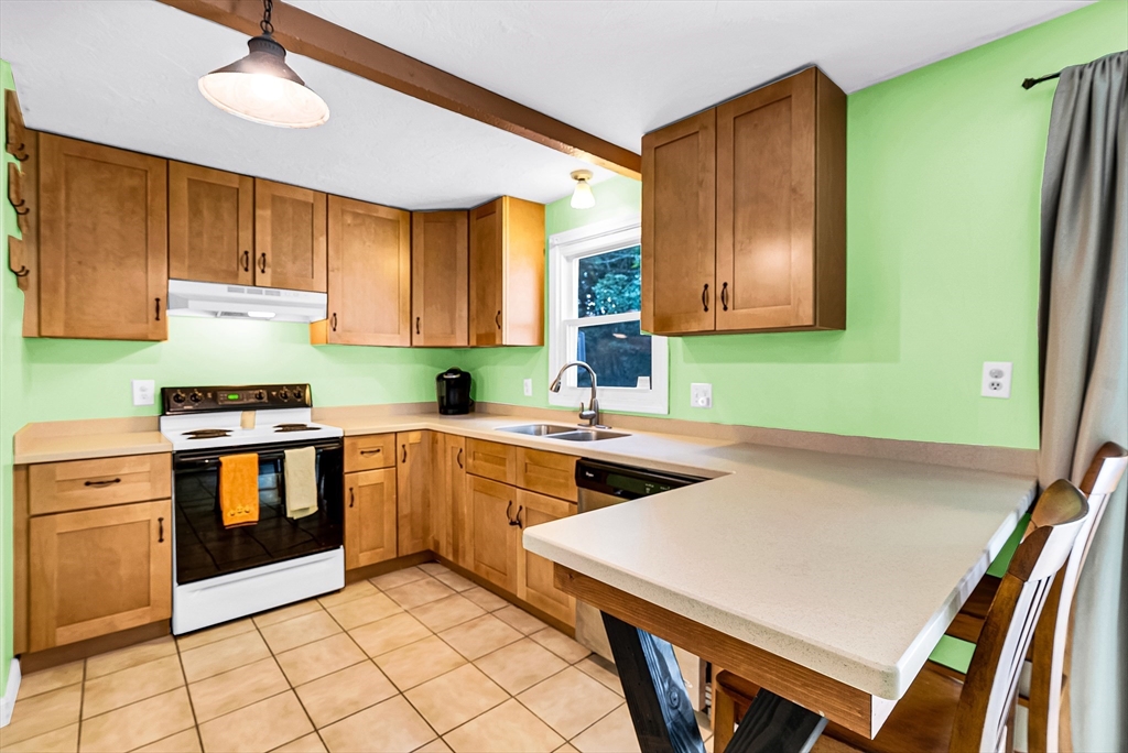 102 Lower Gore Road Webster, MA 01570 - Photo 11 of 40 a kitchen with a stove a sink and a refrigerator