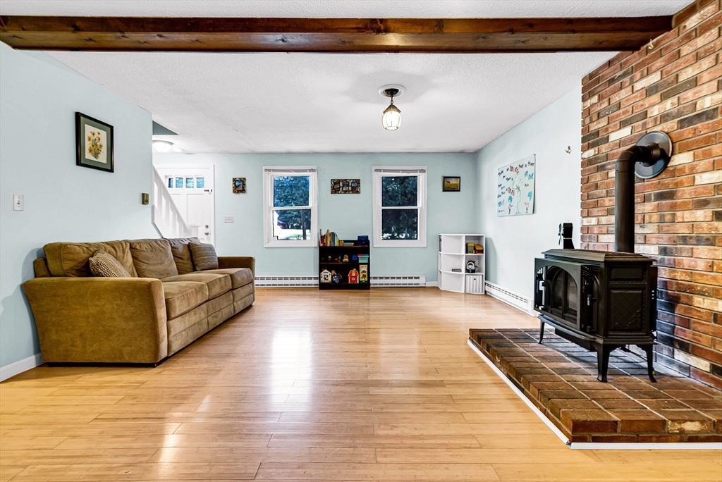 102 Lower Gore Road Webster, MA 01570 - Photo 13 of 40 a living room with furniture and a wooden floor