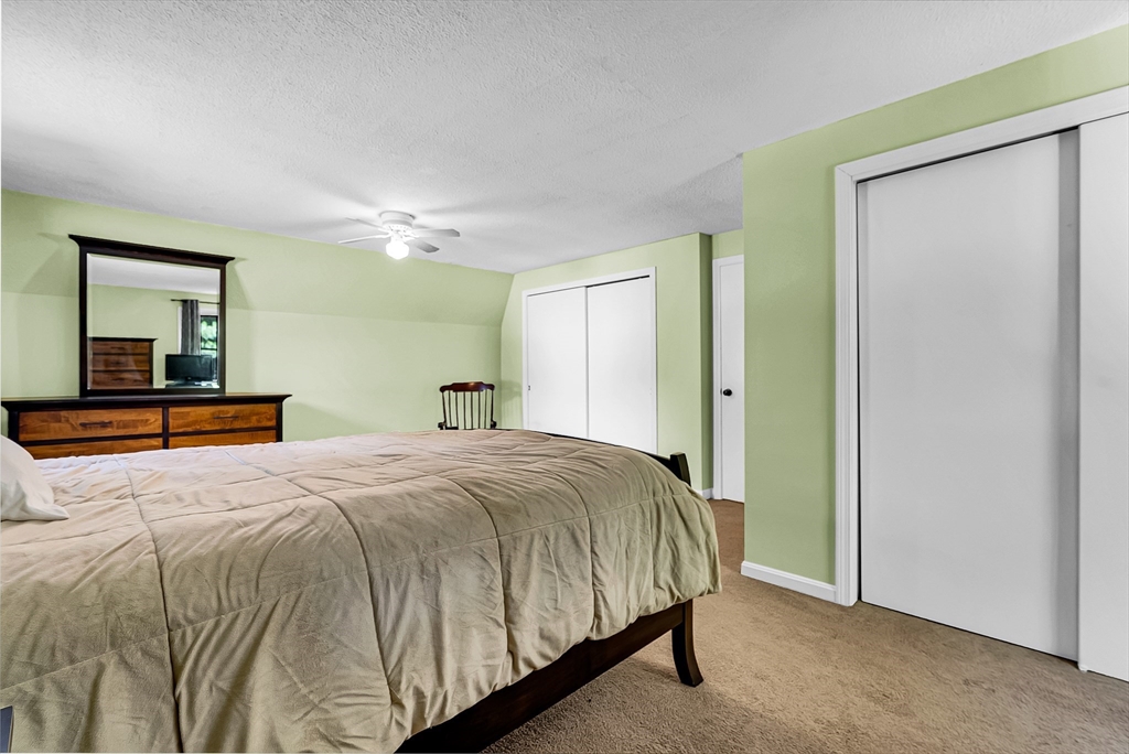 102 Lower Gore Road Webster, MA 01570 - Photo 23 of 40 a bedroom with a bed and a large mirror