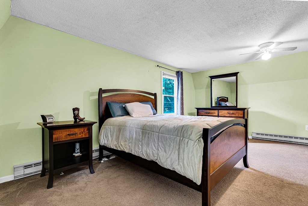 102 Lower Gore Road Webster, MA 01570 - Photo 24 of 40 a bedroom with a bed and a lamp with window