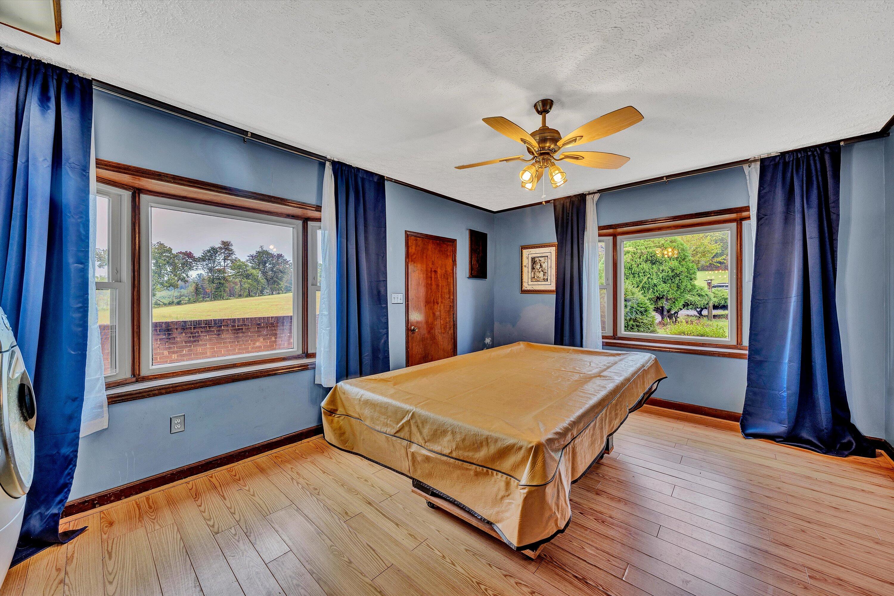 1117 Bouldin Road Ridgeway, VA 24148 - Photo 19 of 70 a living room with a large window chandelier