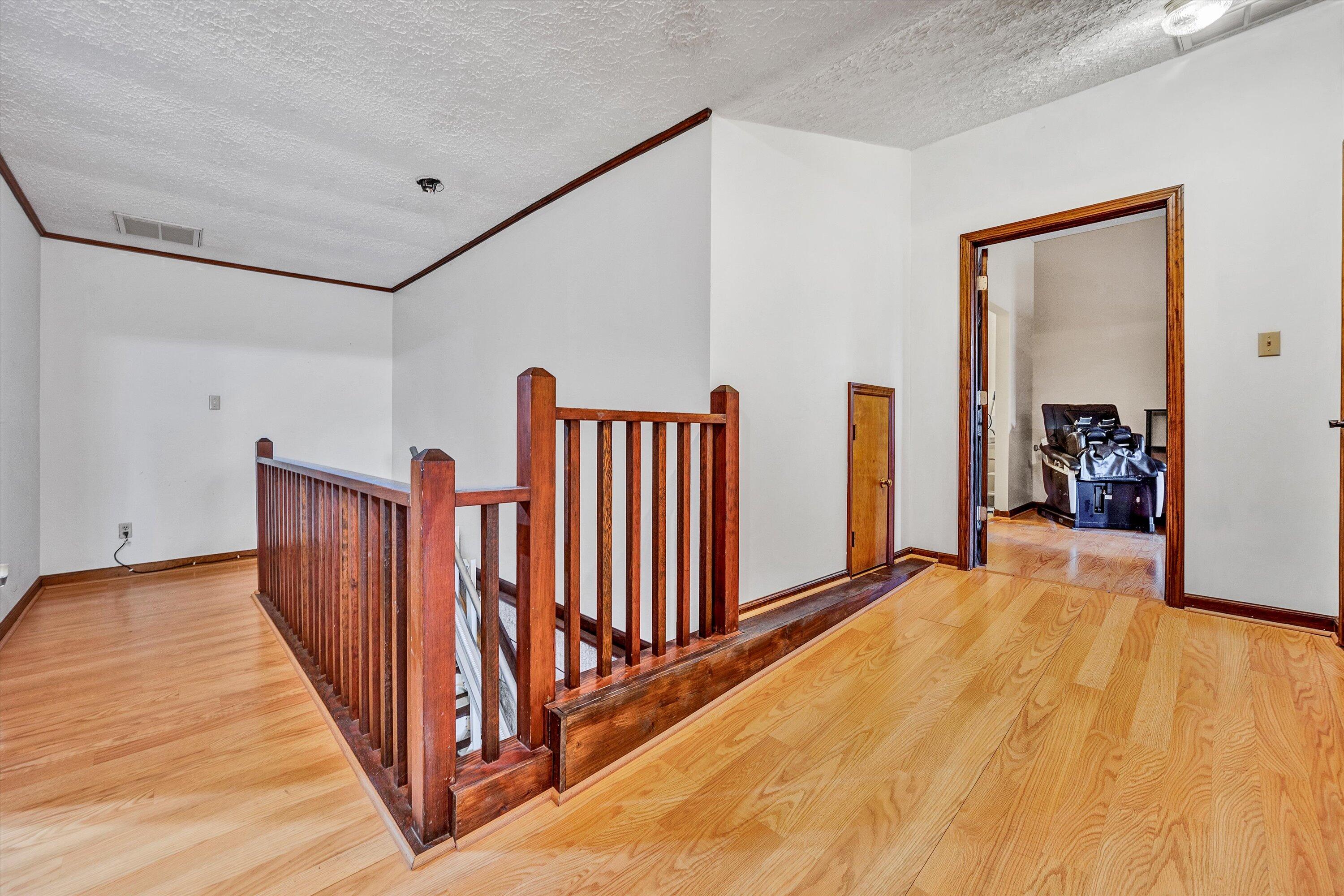 1117 Bouldin Road Ridgeway, VA 24148 - Photo 29 of 70 a view of a hallway with wooden floor and stairs