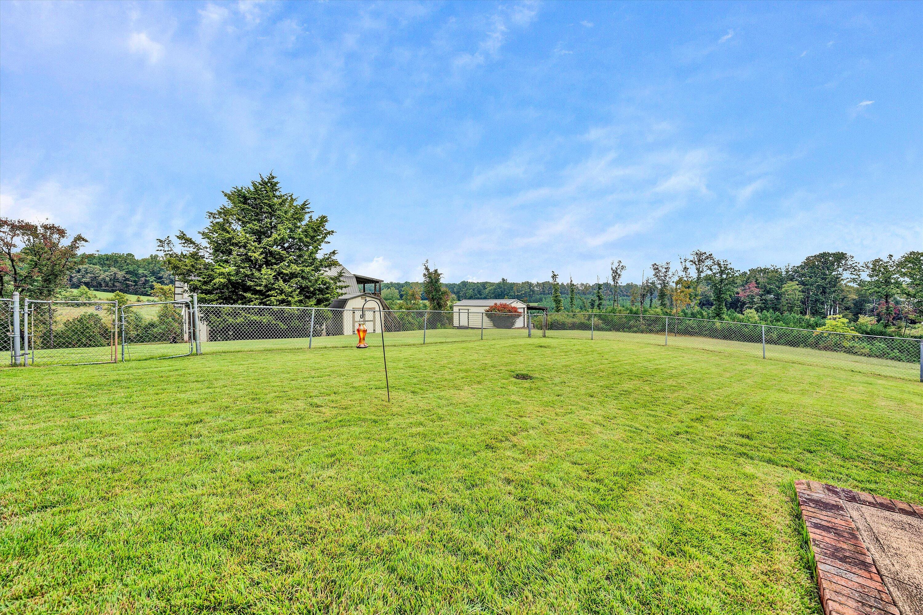 1117 Bouldin Road Ridgeway, VA 24148 - Photo 47 of 70 a view of a green field with wooden fence