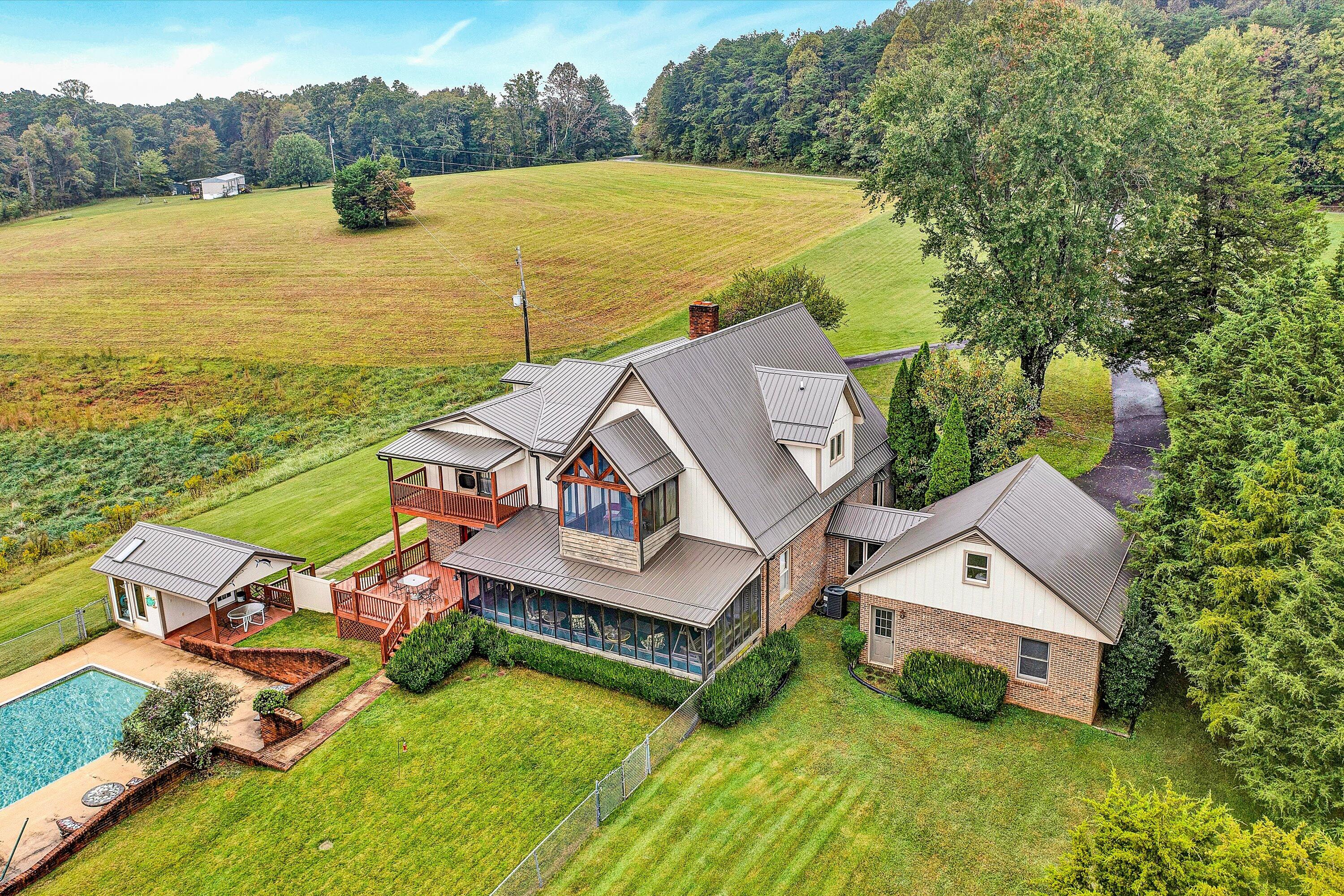 1117 Bouldin Road Ridgeway, VA 24148 - Photo 5 of 70 an aerial view of a house with swimming pool and ocean view