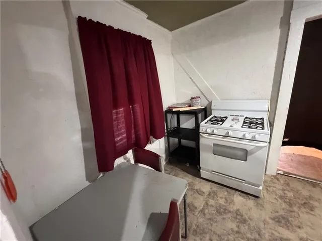 a kitchen with a stove and a refrigerator