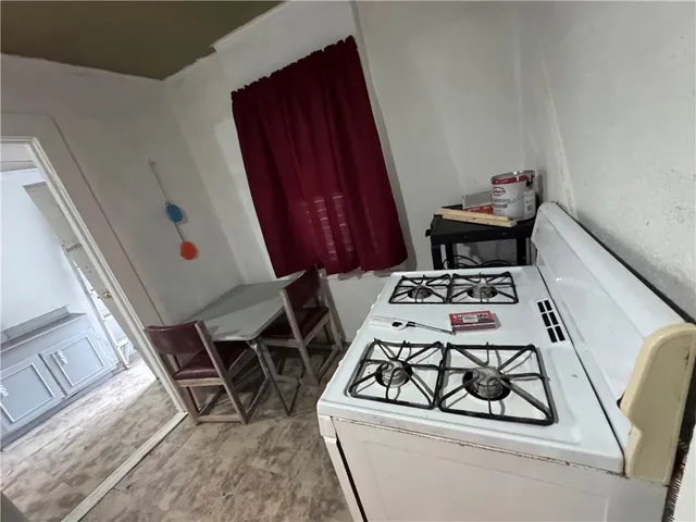 a stove top oven sitting inside of a kitchen