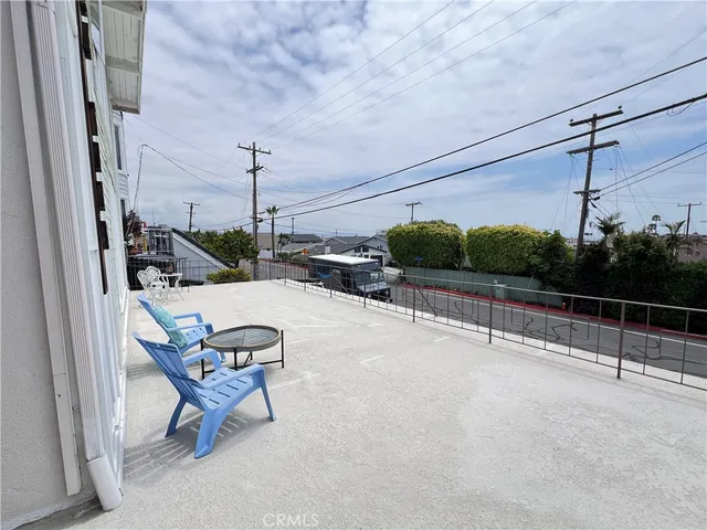 a view of a patio with a table and chairs