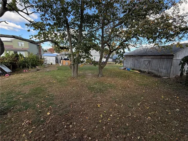 a view of a backyard with large trees