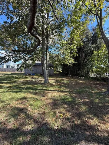 a view of a field with an trees