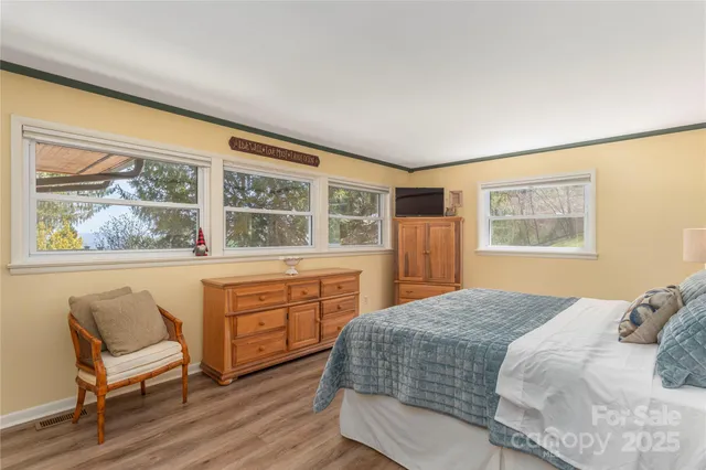 a bedroom with a bed and a large window