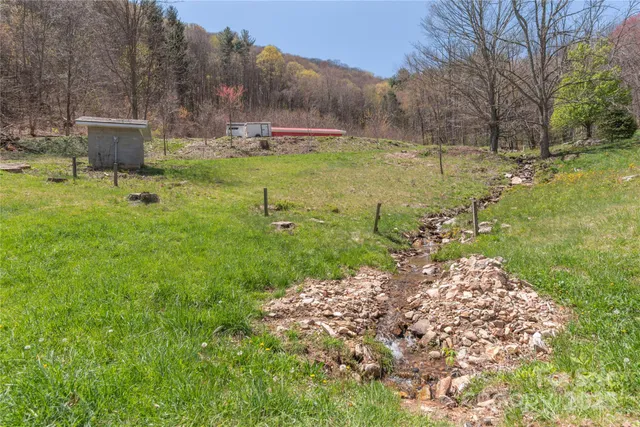 a backyard of a house with yard and outdoor seating