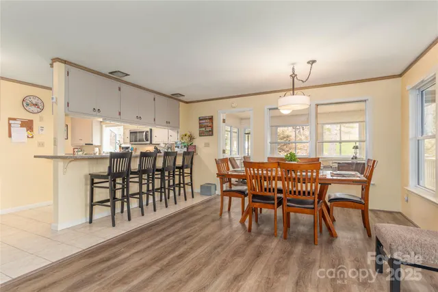 a dining room with furniture and wooden floor
