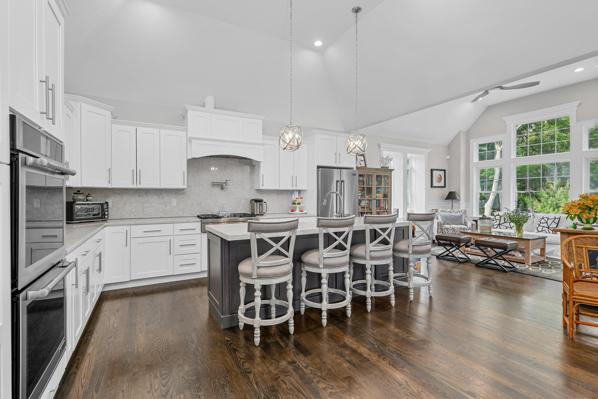 22 Camden Lane Mashpee, MA 02649 - Photo 13 of 46 a kitchen with stainless steel appliances a dining table chairs stove and white cabinets