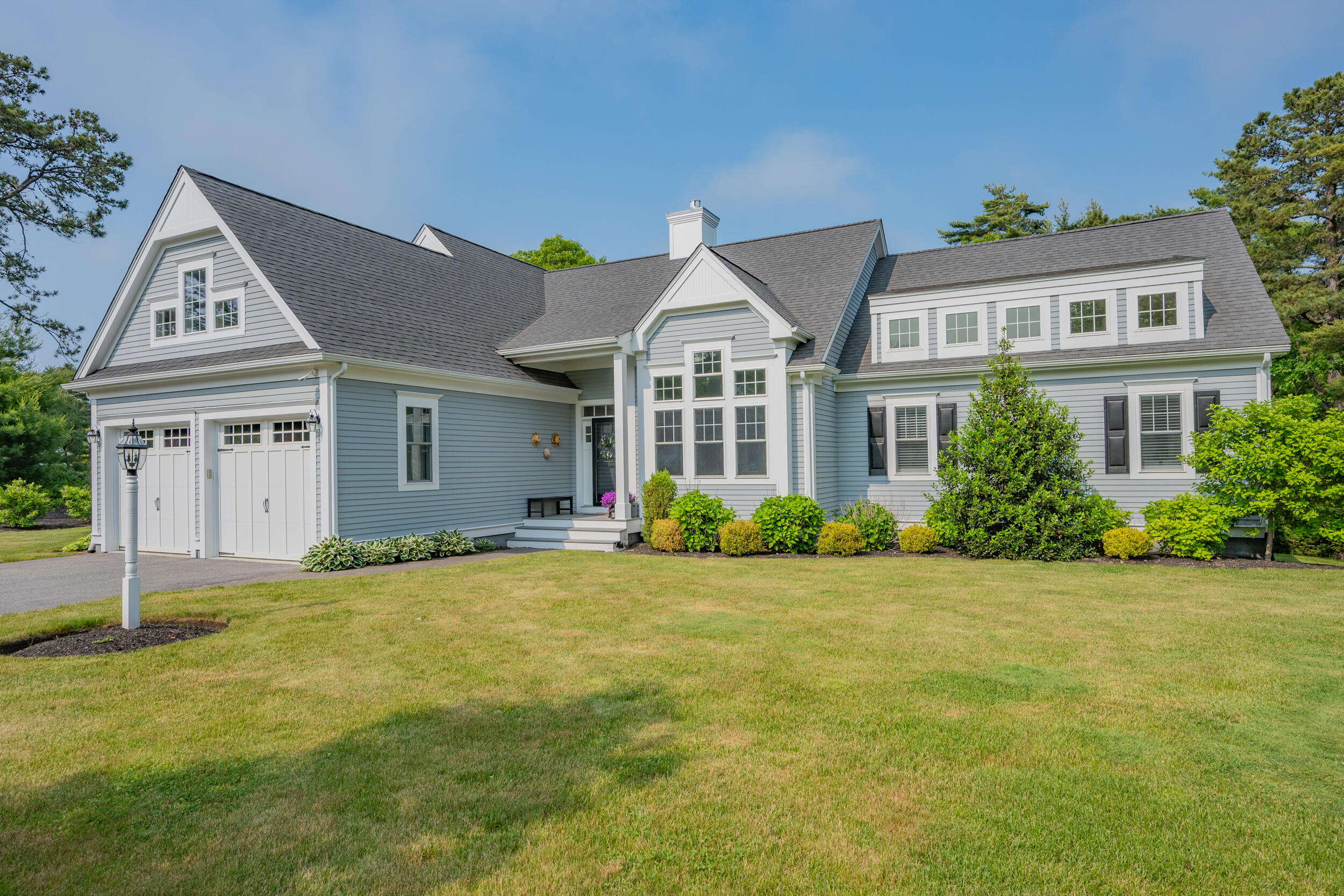 22 Camden Lane Mashpee, MA 02649 - Photo 2 of 46 a front view of a house with a garden