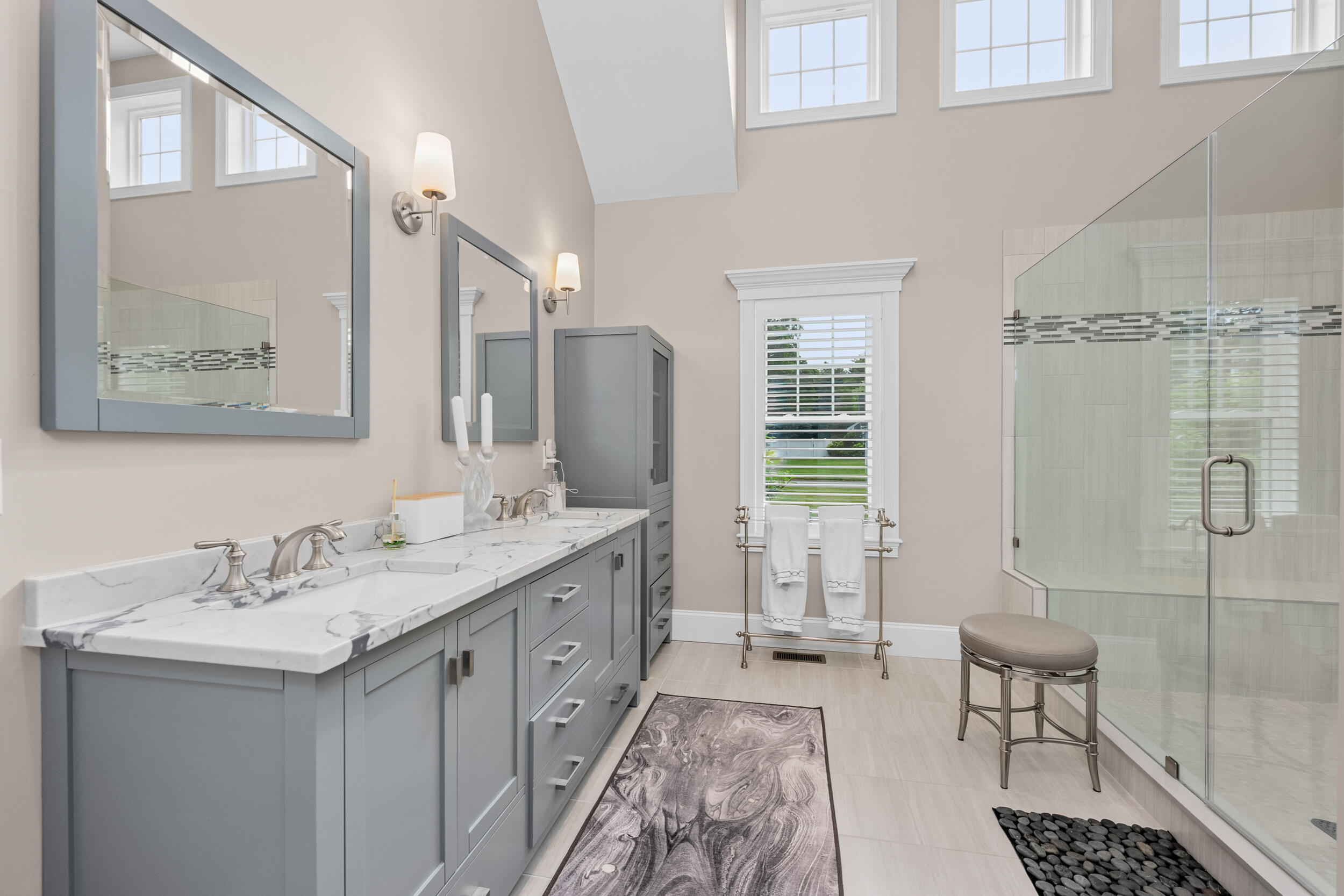 22 Camden Lane Mashpee, MA 02649 - Photo 24 of 46 a spacious bathroom with a double vanity sink a mirror and a shower